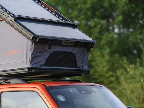 Dovre PRO taktelt montert på oransje SUV – oppslått i grønt skogsområde.