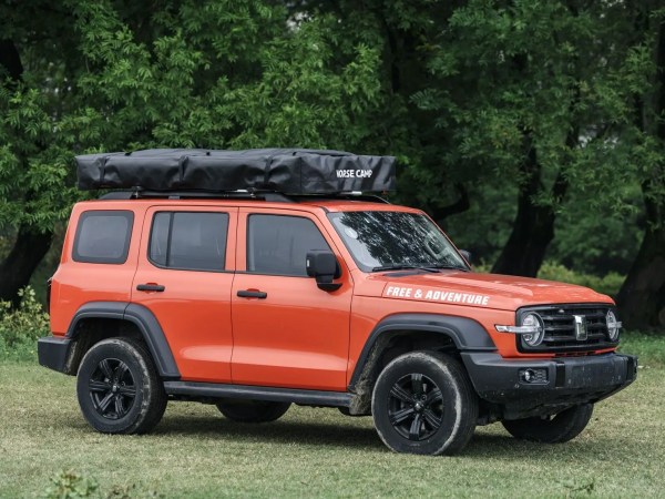 Rondane Wide taktelt nedpakket på oransje SUV – kompakt transportstilling i skogmiljø.