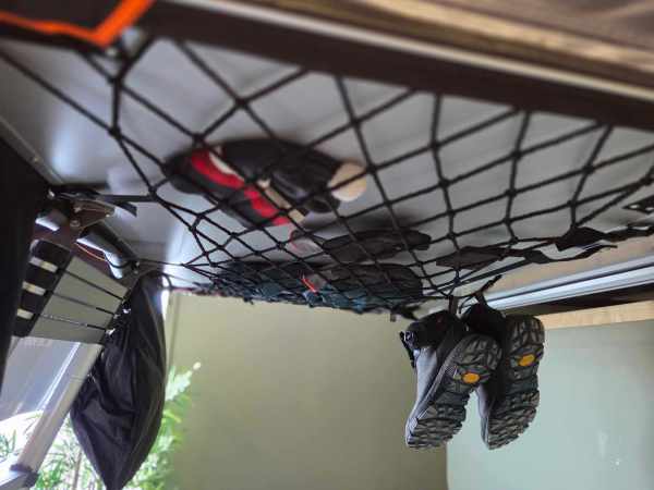 Tørkenett i bruk med klær og sko hengende til tørk.